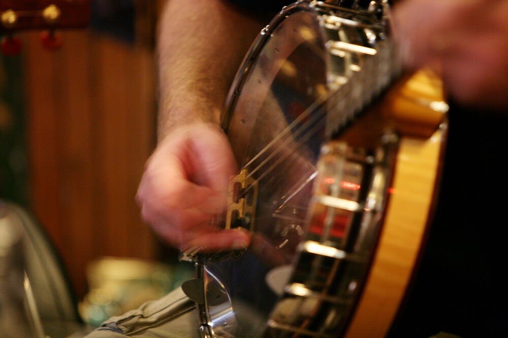 man playing guitar in bar 